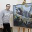 Андрей Чернов со своей картиной “Проводы брата в армию”.