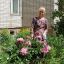 Маргарита Николаевна ухаживает за цветами во дворе дома № 35 по ул. 10-й пятилетки.